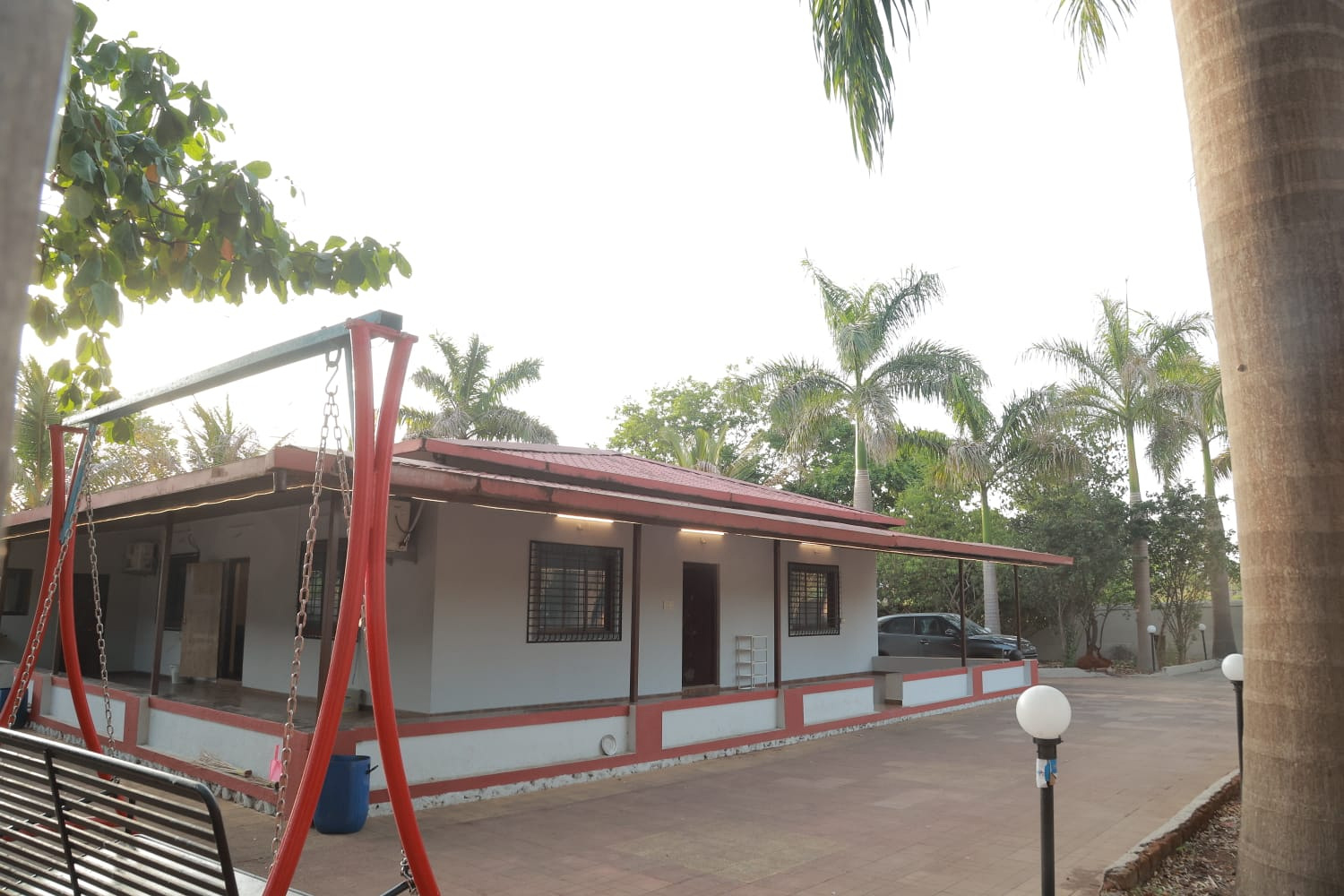 Dessitera Villa Karjat private swimming pool, 1-acre lawn and luxury estate illuminated at dusk