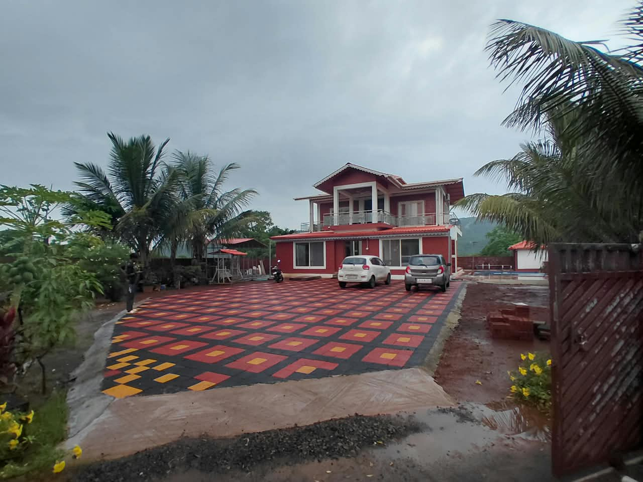 Golden Leaf Villa Alibag private luxury pool villa exterior, swimming pool and lush tropical palms